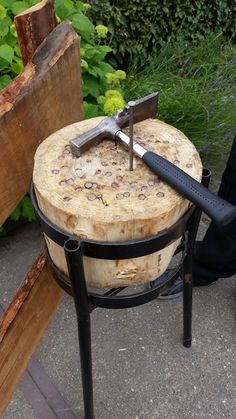 a knife that is sitting on top of a piece of wood next to a bench