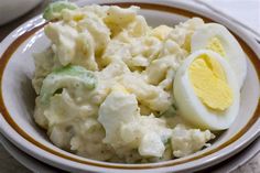 a white bowl filled with mashed potatoes and an egg