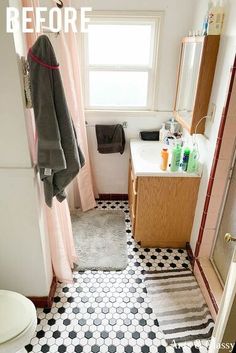 a bathroom with black and white tile flooring