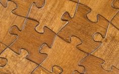 a piece of wood that has been made to look like puzzles on the floor