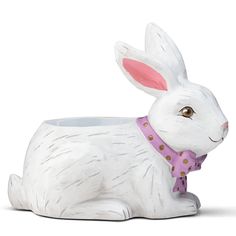 a white rabbit planter with a pink bow tie on it's neck and ears