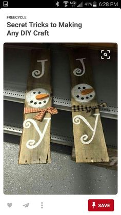 two snowmen made out of wooden planks sitting on top of a metal shelf