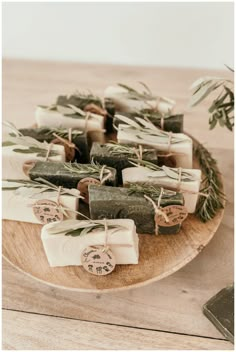 soaps with rosemary and sage on a wooden plate