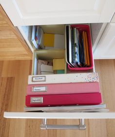 an open drawer with many files and folders in it