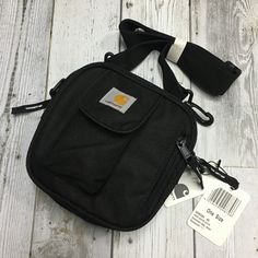 Brand New With Tag Color: Black Size: 6¾"W X 6¾"H X 2¾"D Adjustable Shoulder Strap. Purpose: Outdoor Bag. Phone Bag. Decorative Bag. Carhartt Bag, Tech Bag, Men Carhartt, Bags For Men, Outdoor Bag, Duffel Bags, Shoulder Bag Black, Carhartt Wip, Phone Bag