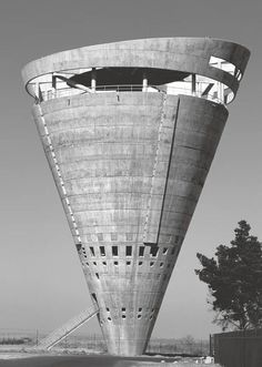 a very tall building sitting on the side of a road