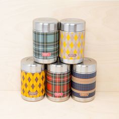 six canisters are stacked on top of each other