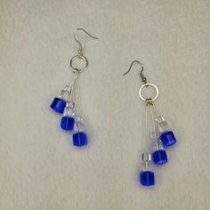 blue glass beads hang from silver earwires