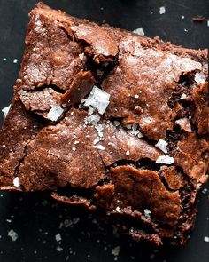 two brownies with sea salt on top and one has been cut in half to eat