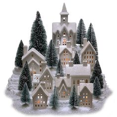 a christmas village with snow covered trees and lit up lights on the houses is shown