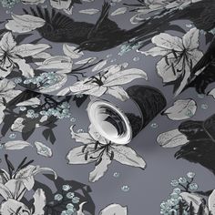 a black and white floral pattern on a gray background with blue flowers, leaves and birds