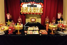 a table topped with lots of candy and candies on top of a black table cloth