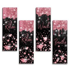 three pink and black wall hangings with glitter