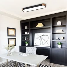 a dining room with black and white decor