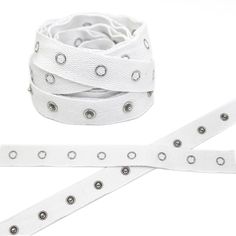 a white belt with silver studs on the side and two rows of belts attached to it