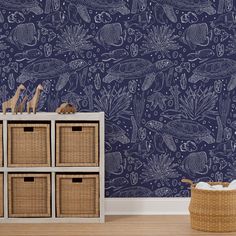 a blue wallpapered room with baskets and toy animals on the dresser next to it