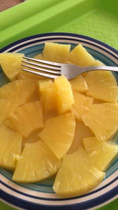 a plate with pineapple slices and a fork on it