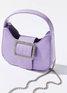 Alison Baguette Bag Sweet and simple lavender handbag topped with an oversized rhinestone buckle for subtle drama. Includes a chain strap option for more ways to wear. - 100% Polyurethane - Spot clean - Imported Size - Length: 7.375” - Width: 2.125” - Height: 5.375” - Strap drop: 21.75” - Handle drop: 4” Lavender Purse, Tiny Purse, Mini Duffle Bag, Urban Outfitters Bags, Urban Outfitters Bag, Faux Leather Handbag, Baguette Bag, Mini Tote Bag, Mini Crossbody Bag