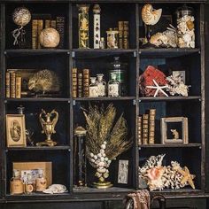 an old bookcase filled with lots of books and other decorative items on top of it