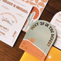 wedding stationery and save the date cards on a wooden table with orange envelopes