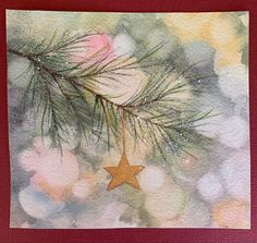 a watercolor painting of a pine tree branch with a star hanging from it's center