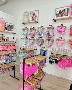 a room filled with lots of different types of bikinis and bras on display