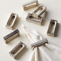 napkin rings and napkin clips on a white surface