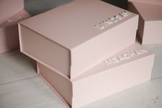 three pink boxes are stacked on top of each other