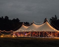 a large tent is lit up with fairy lights