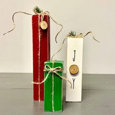 two wooden boxes tied with twine and rope, one has a tag that says joy