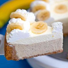 a piece of cheesecake with bananas on top is being held up by a fork