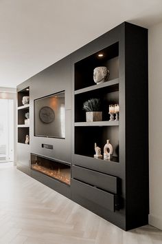 a modern living room with fireplace and entertainment center