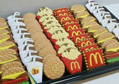 a tray filled with lots of different types of cookies on top of a table next to each other