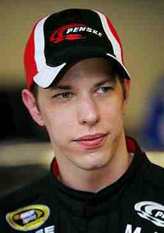 a close up of a person wearing a hat and looking at the camera with a serious look on his face