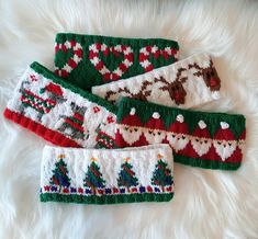 three knitted christmas headbands laying on top of a white furnishing