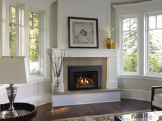 a living room filled with furniture and a fire place in the middle of a room