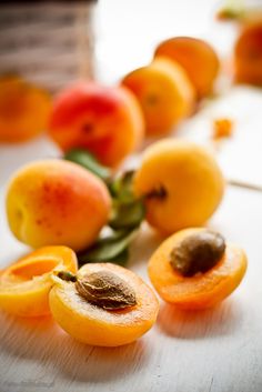 several pieces of apricot sitting on top of a wooden table next to each other