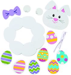 an assortment of paper crafts including eggs, bows and bunny ears on a white background