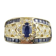 Vintage 14k Yellow Gold Sapphire And Diamond Ring Size 6.75- This Sparkling Ring Features One Oval Sapphire (6 Mm X 5 Mm), 20 Square Cut Sapphires And 32 Round Single Cut Diamonds Set In Classic 14k Yellow Gold. Width: 11 Mm. Shank: 4 Mm. Approximate Total Diamond Weight: .20 Ct. Diamond Color: I Diamond Clarity: Si1-I1 Ring Size: 6.75 Stamped: 14k Weight: 7.0 Gr./ 4.5 Dwt. Very Good Condition, Professionally Polished. Will Come Packaged In A Gift Box Or Pouch (When Possible) And Will Be Shipped U.S. Priority Mail Insured. Dv121823/17kcs Jagi Id 10/16 Sapphire And Diamond Ring, Sparkling Rings, Square Cut, Diamond Color, Natural Sapphire, Diamond Clarity, Womens Jewelry Rings, Estate Jewelry, Blue Gold