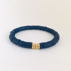 Stretch bracelet made with 6mm navy blue vinyl heishi rondelle beads and accented with gold spacer beads. It is strung on high quality stretch cord and will be made in a 7 inch average size that will fit most wrists. If a smaller or larger size is needed, please leave a note in the comments section at checkout. If unsure about size, measure your wrist and add 1/2 inch to the measurement. Clay Bead Jewelry, Surf Necklace, Heishi Bracelet, Green Beaded Bracelets, Wire Wrapped Bangles, Wire Bangles