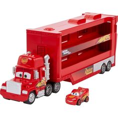 a red toy truck with cars next to it