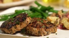 some meat patties and green beans on a plate