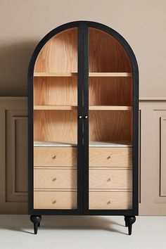 an arch shaped cabinet with drawers in it