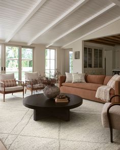 a living room filled with furniture and windows