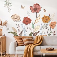 a living room with flowers painted on the wall and a couch in front of it