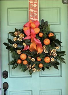 a green door with an orange wreath on it