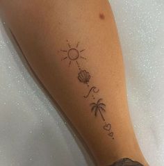 a woman's foot with a tattoo on it that says love and palm trees