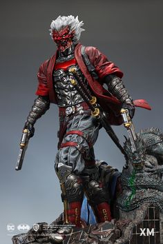 an action figure is posed on top of a statue