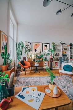 a living room filled with furniture and lots of plants