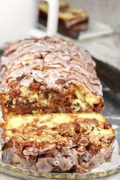 a loaf of apple fritter cake sitting on top of a glass plate